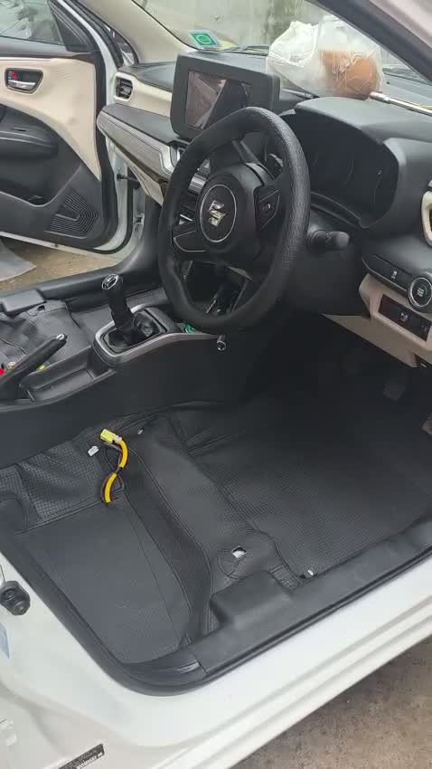 Still from supplied footage showing a fitted black floor covering inside a car