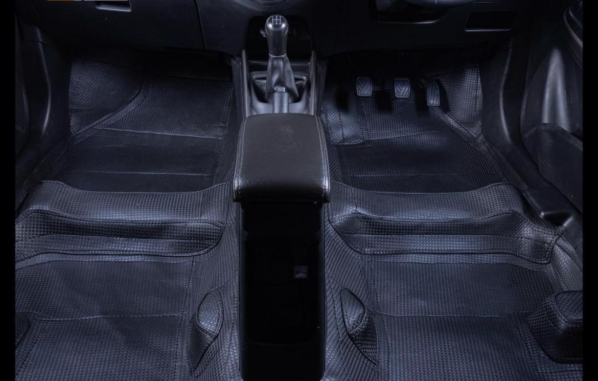 Supplied Carzio photograph of a textured black interior floor mat covering the front footwells around the centre console